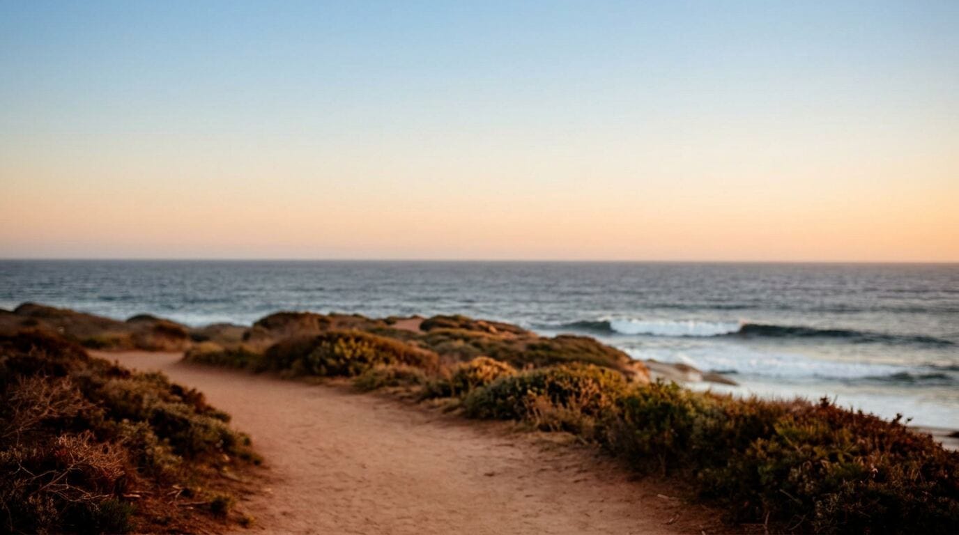 A healthy, active couple walking together along a coastal path at first light
